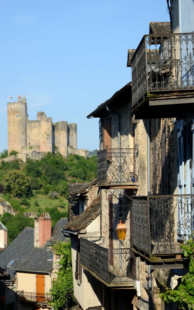 Vue sur la forteresse de Najac depuis le village avec des maisons aux balcons en fer forgé